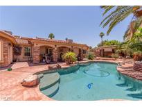 Beautiful pool and patio with palm trees and outdoor grilling area perfect for outdoor entertaining at 3085 Duneville St, Las Vegas, NV 89146