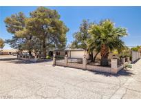Charming single-story home featuring desert landscaping and a secure brick and wrought iron fenced yard at 3090 Westwind Rd, Las Vegas, NV 89146