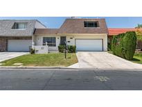 Charming home featuring well-maintained landscaping, a two-car garage, and a welcoming entrance at 3785 Decade St, Las Vegas, NV 89121