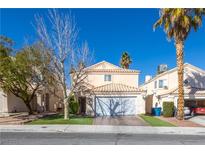 Charming two-story home features a tile roof, attached garage, and well-maintained landscaping with mature trees at 433 Jubilation Dr, Las Vegas, NV 89145
