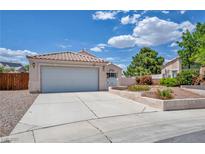 Charming single-story home with a two-car garage, low-maintenance desert landscaping, and a tile roof at 5139 Zapata Ln, North Las Vegas, NV 89031
