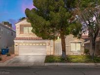 Inviting two-story home featuring a two-car garage and well-maintained front yard at 7924 Mcdowell Dr, Las Vegas, NV 89129