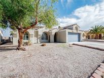 Charming single-story home featuring stucco siding, a blue garage door, and low-maintenance desert landscaping at 849 Brahma Ln, Henderson, NV 89002