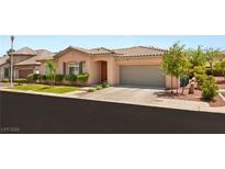 Charming single-story home featuring a tile roof, well-manicured lawn, and a two-car garage at 10463 Pioneer Park Ave, Las Vegas, NV 89135