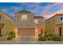 Beautiful two-story home featuring a two-car garage, desert landscaping, and a charming red front door at 106 Rock Crossing Ave, North Las Vegas, NV 89031