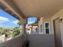 Cozy balcony with a view of palm trees and a glimpse of the blue sky at 1320 Driscoll Dr # 201, Las Vegas, NV 89128