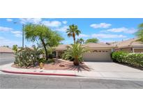 Charming single-story home featuring a well-maintained yard and desert landscaping with palm trees at 1789 Castro Hill Ave, Henderson, NV 89012