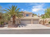 Inviting two-story home featuring a three-car garage, desert landscaping and a mature palm tree in front at 1795 Nuevo Rd, Henderson, NV 89014
