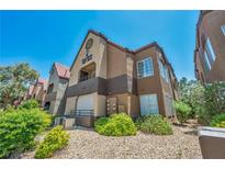 A view of the exterior with desert landscaping and a terracotta-colored roof against a clear blue sky at 2200 S Fort Apache Rd # 2041, Las Vegas, NV 89117