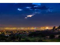 Striking Las Vegas city view featuring the skyline and a golf course at dusk at 2786 Scotts Valley Dr, Henderson, NV 89052
