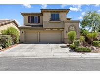 Inviting two-story home boasts a three-car garage and meticulous desert landscaping at 3405 Brook Song Ave, North Las Vegas, NV 89081