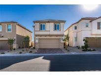 Inviting two-story home featuring a neutral color palette, two-car garage and manicured front yard at 3921 Painted Lady Ave, Las Vegas, NV 89141