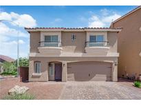 Charming two-story home features two balconies, a two-car garage, and a well-maintained front yard at 5616 Canoe Ridge Ct, Las Vegas, NV 89141