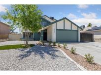 Charming two-story home with a lush tree in the front yard and a well-maintained lawn at 6999 Montcliff Ave, Las Vegas, NV 89147