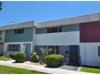 A quaint two story townhouse featuring fresh landscaping and curb appeal at 745 Greenbriar Townhouse Way, Las Vegas, NV 89121