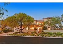 Beautiful home featuring manicured landscaping and inviting curb appeal with mature trees at 1404 Reisling Ct, Las Vegas, NV 89144