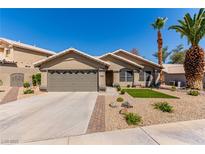 Charming single-story home features desert landscaping and a two-car garage, enhancing its curb appeal at 1761 Summerwood Cir, Henderson, NV 89012