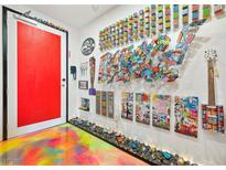 Hallway with colorful floor and walls decorated with artwork and Rubik's cubes at 200 Hoover Ave # 1813, Las Vegas, NV 89101