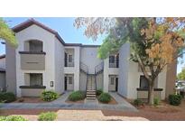 The exterior of this building features a central staircase and well-maintained landscaping at 2615 W Gary Ave # 2061, Las Vegas, NV 89123