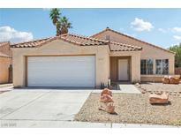 Charming single-story home featuring desert landscaping, a two-car garage and a tile roof at 2717 Pastel Ave, Henderson, NV 89074