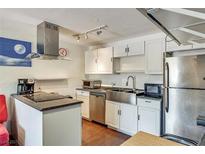 Modern kitchen features stainless steel appliances, a large stainless steel sink, and stylish track lighting at 3712 Royal Crest St # 14, Las Vegas, NV 89119