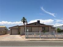 Charming single-story home featuring a white picket fence and desert landscaping at 462 Crestway Rd, Henderson, NV 89015