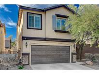 Two-story home with a two-car garage and desert landscaping at 4727 Sweeping Glen St, Las Vegas, NV 89129