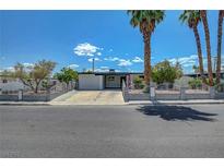 Charming single-story home with a well-manicured front yard and gated perimeter providing an inviting curb appeal at 4807 Sacks Dr, Las Vegas, NV 89122