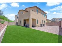Expansive backyard featuring lush green grass, covered patio and brick paved area at 4833 Royal Magnolia St, North Las Vegas, NV 89031