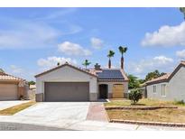 Single-story home with desert landscaping, solar panels, and a spacious two-car garage at 4911 Ranchodomingo Ct, North Las Vegas, NV 89031