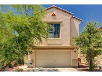 Charming two-story home with a two-car garage, a well-kept lawn, and mature trees in a residential neighborhood at 5220 Melbourne Ridge Ct, Las Vegas, NV 89141