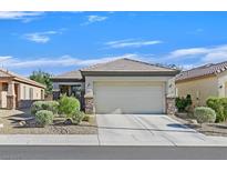 Charming single-story home featuring desert landscaping and a two-car garage at 6141 Tokara Ave, Las Vegas, NV 89122