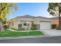 Charming single-story home with a two-car garage, well-manicured lawn and tidy landscaping at 713 Chase Tree St, Las Vegas, NV 89144