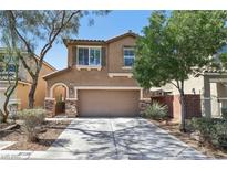 Charming two-story home featuring a two-car garage, desert landscaping, and a welcoming front entrance at 7407 Bakewell Ave, Las Vegas, NV 89179