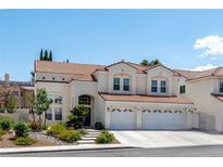 Stunning two-story home featuring a red tile roof, three car garage, and manicured landscaping at 8113 Blue Cascade Ave, Las Vegas, NV 89128
