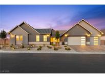 Charming single-story home featuring a three-car garage and beautifully landscaped front yard at 8840 Harvest Sunset St, Las Vegas, NV 89113
