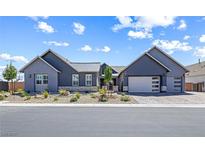 Beautiful single-story home featuring a gray exterior, two-car garage, and professionally landscaped front yard at 8840 Harvest Sunset St, Las Vegas, NV 89113