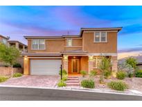 Charming two-story home boasts a well-manicured front yard, brick-paved driveway, and a welcoming entrance at 928 Riverlawn Pl, Las Vegas, NV 89138