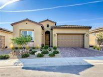 Charming single-story home with a well-manicured front yard and paver driveway leading to a two-car garage at 146 Cabo Cruces Dr, Henderson, NV 89011