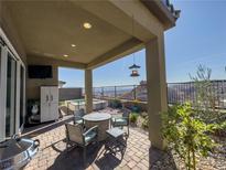 Enjoy outdoor living on this covered patio with mountain views and a cozy seating area, perfect for relaxing outdoors at 146 Cabo Cruces Dr, Henderson, NV 89011
