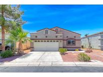 Charming single-story home featuring a two-car garage and landscaped front yard with a palm tree at 1717 Dwayne Stedman Ave, Las Vegas, NV 89106