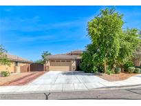 Charming single-story home featuring a two-car garage, mature trees, and a well-maintained yard at 1727 Sonoran Bluff Ave, Henderson, NV 89014