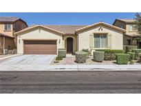 Charming single-story home featuring a well-manicured front yard and a two-car attached garage at 1792 Gentle Brook St, North Las Vegas, NV 89084