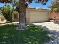 Charming single-story home featuring a well-manicured lawn and a two-car garage in a residential neighborhood at 2105 Kendall Hill Ave, Las Vegas, NV 89106