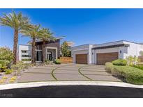 Modern home showcasing a meticulously landscaped front yard and stylish architectural design at 2610 Eldora Estates Ct, Las Vegas, NV 89117