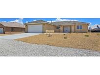 Charming single story home showcasing well kept front yard and two car garage at 3016 Mount Charleston Dr, Pahrump, NV 89048