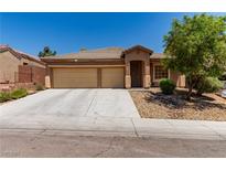 Charming single-story home featuring a two-car garage, well-kept landscaping, and a welcoming entrance at 312 Purple Passion Ave, North Las Vegas, NV 89032