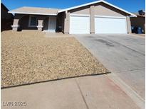 Charming single-story home with a two-car garage, low-maintenance landscaping, and a welcoming entrance at 3318 Covey Ln, Las Vegas, NV 89115