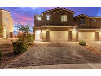Charming two-story home featuring a brick driveway and a two-car garage at 360 Rosefinch St, Henderson, NV 89012