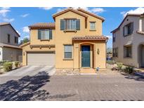Two-story home featuring a two car garage, shutters, landscaping, and a brick paved driveway at 5324 Pendergrass St, North Las Vegas, NV 89081